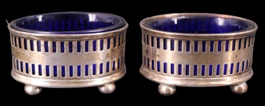 A pair of 1940s silver salt cellars, of oval section decorated with geometric reticulation, having
