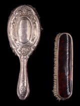 A 1920s silver-mounted brush together with a white-metal hairbrush, (latter a/f)