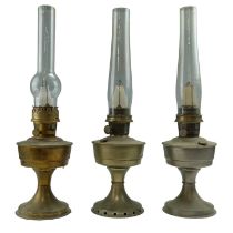 Three Aladdin oil lamps; numbers 12, 21 and 23, tallest 60 cm