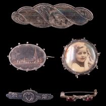 Five Victorian and later silver / white metal brooches, including a locket, one engraved in