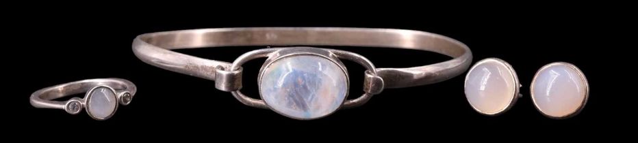 Four items of moonstone and sapphire jewellery, comprising a bracelet with a 12 x 16 mm bezel set