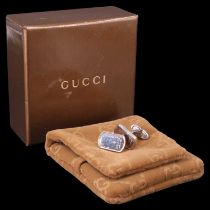 A pair of Gucci white-metal cufflinks in original box with a monogrammed soft travel pouch and