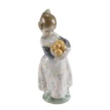 A Lladro figurine of a young girl holding a basket of fruit, height 17.5 cm
