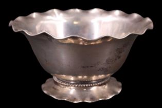A Finnish white metal bowl having a wavy edge rim and foot with a beaded collar, 813 standard, K