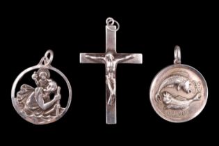 Three white metal pendants, comprising a crucifix, a St Christopher, and a Piscese astrological