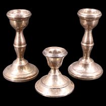 A pair of 1970s silver candlesticks together with a similar single Edward VII candle stand,