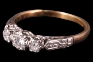 A George V three stone diamond ring, having a central 3 mm brilliant diamond between two 2 mm