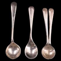 A pair of silver Hanoverian pattern salt spoons, together with two other early 20th Century