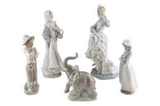 A group of NAO figurines comprising a large dancer, a woman, two children and an elephant, tallest