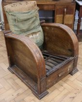 An Art Deco oak reclining armchair, having magazine compartments to the sides, circa 1930s, 66 x