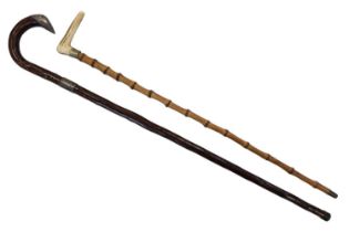 A silver mounted walking cane together with an antler-handled stick, former 90 cm