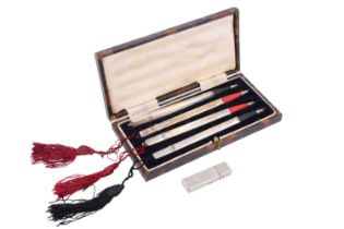 A cased set of four sterling standard white metal propelling bridge pencils together with