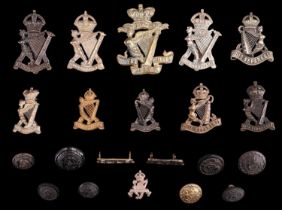A group of Royal Irish Regiment / Rifles cap and other badges and insignia