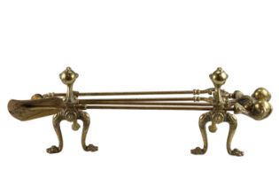 A pair of reproduction claw-and-ball brass andirons together with a matching fire implement trio,