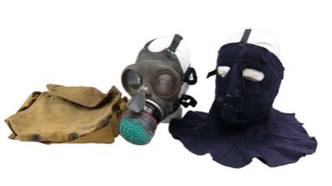 A Second World War Civilian Duty gas mask together with a fabric face protector and a respirator