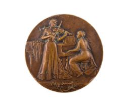An early 20th Century bronze medallion by CH Pillet, decorated in depiction of musicians, a vacant