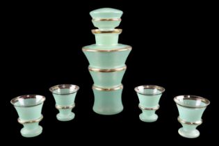 A moderne turquoise flashed and gilt glass liqueur decanter and four matching glasses, circa