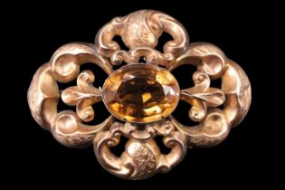 A Victorian citrine openwork brooch, comprising a 12 x 15 mm oval citrine, set in a bezel within