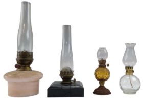 Three oil lamps having glass reservoirs, together with one other lamp, tallest 42 cm