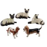 Two Beswick dog figurines comprising a King Charles Spaniel and a Bassett Hound, together with three