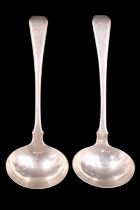 A pair of George III silver Hanoverian sauce ladles both bearing an engraved initial letter M to the