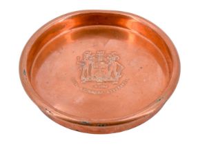 A Royal Exchange Assurance heavy copper dish, the centre decorated with a raised armorial and