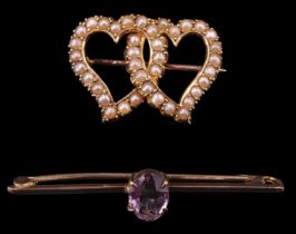 An Edwardian pearl set double heart brooch, comprising two interlocking yellow metal openwork