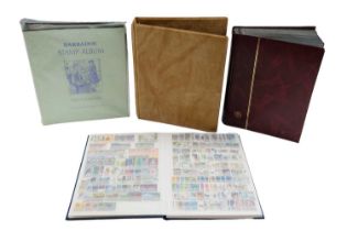 Four albums containing a diverse collection of world and commonwealth stamps