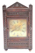 A late 19th-century chip-carved carved oak mantle or shelf clock, 28 cm x 17 cm x 12 cm (runs