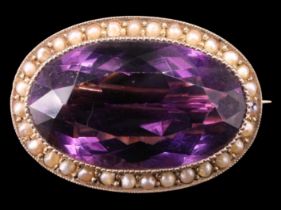 A Victorian amethyst and pearl brooch, the 14 x 23 mm oval set in a millegraine bezel and surrounded