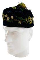 A Victorian deep blue velvet smoking cap, decorated with hand embroidered blossom and foliage,