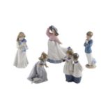 Five Nao figurines including choir boys and a young girl and dog, tallest 24 cm