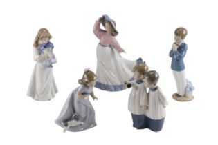 Five Nao figurines including choir boys and a young girl and dog, tallest 24 cm