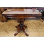 A Victorian mahogany turn-over-top tea table, having a columnar support with four carved legs, 91