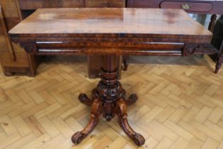 A Victorian mahogany turn-over-top tea table, having a columnar support with four carved legs, 91