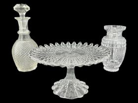 A finely cut floral decorated glass vase, a pressed decanter and a cake stand, decanter 28 cm