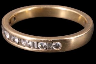 A diamond half-hoop eternity ring, the 18 ct gold band channel-set with alternate brilliant and