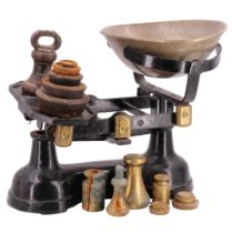 A set of early-to-mid 20th Century brass-mounted cast iron grocer's scales together with a nested
