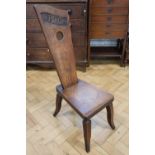 A 1944 carved oak spinning stool, 91 cm