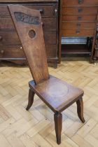 A 1944 carved oak spinning stool, 91 cm