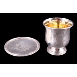 A late Victorian portable silver Christian chalice and paten, each bearing an engraved Christogram