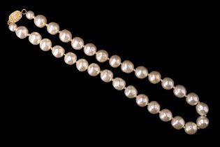 A late 20th Century faux pearl necklace having a 9ct gold textured box clasp, length 42 cm