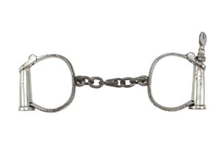 A set of early 20th Century Derby-type handcuffs by W Dowler & Sons of Birmingham, stamped "W Dowler