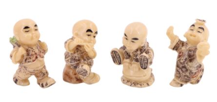 Four miniature Japanese resin figurines of young monks, character marks to bases, tallest 5 cm