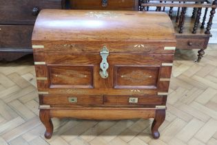 An Indian brass-inlaid mahogany chest, having a "domed" top with brass hasp and padlock opening to