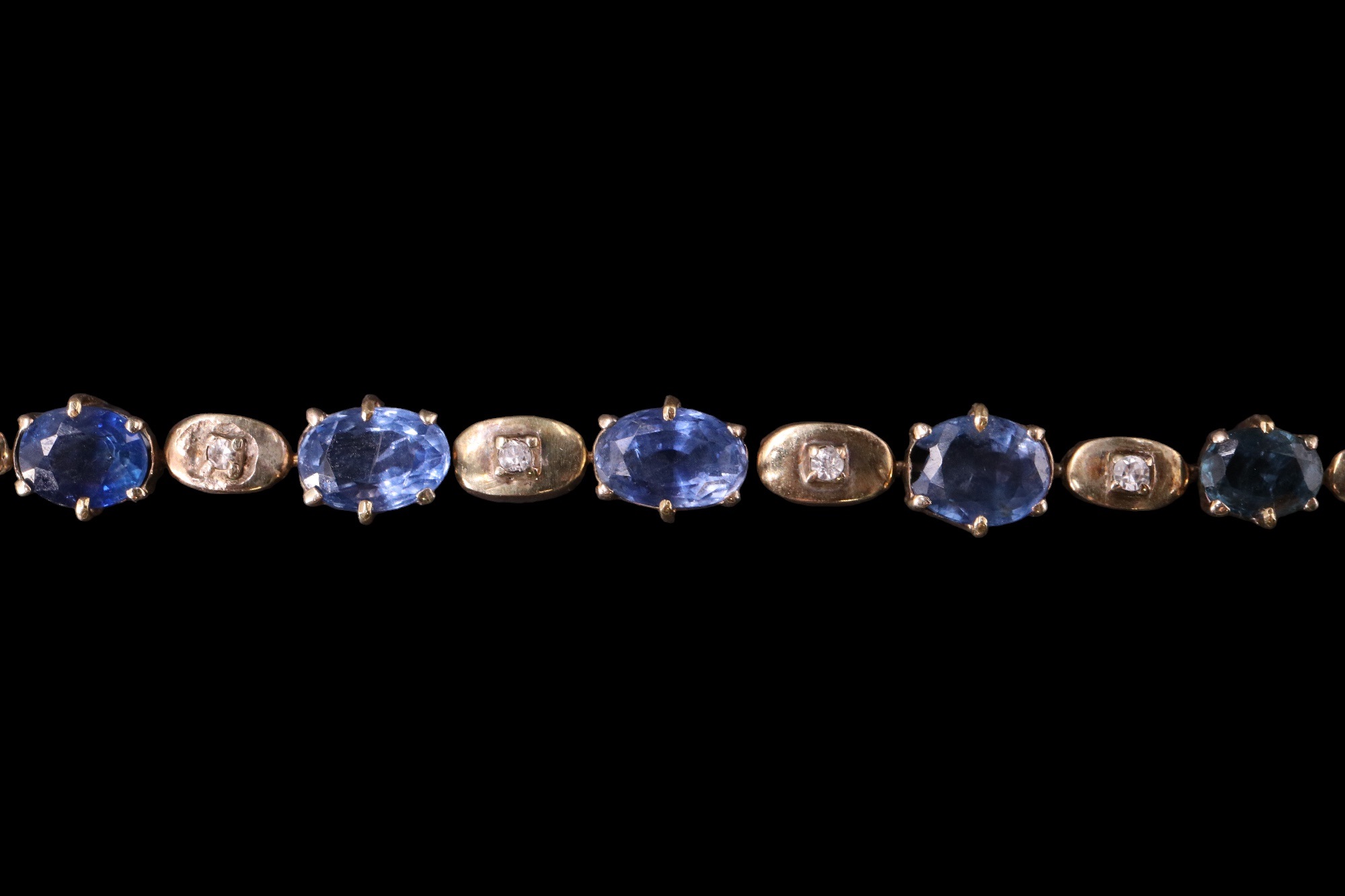 A sapphire and diamond bracelet, having seven graduated oval sapphires of approximately 3 carats - Image 2 of 3