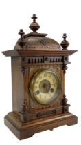 A late 19th Century German oak mantel clock, having a Junghans two-train movement striking on a