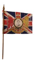 A printed cotton Union Jack flag to commemorate Queen Elizabeth's 1953 Coronation, mounted on a