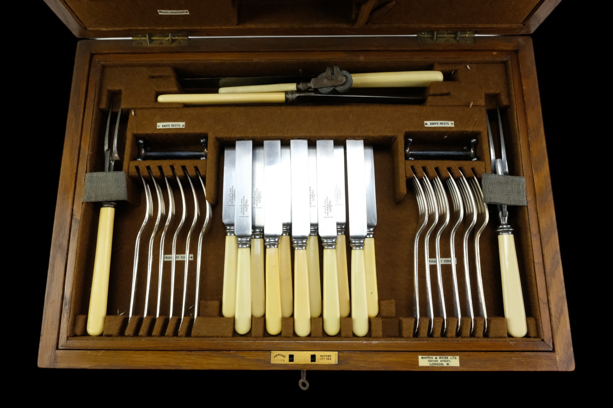 A Mappin & Webb brass-mounted oak canteen containing a suite of Ivorine and electroplate cutlery and - Image 2 of 4