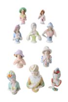 Ten Victorian and early 20th Century ceramic pin cushion ladies, tallest 11 cm